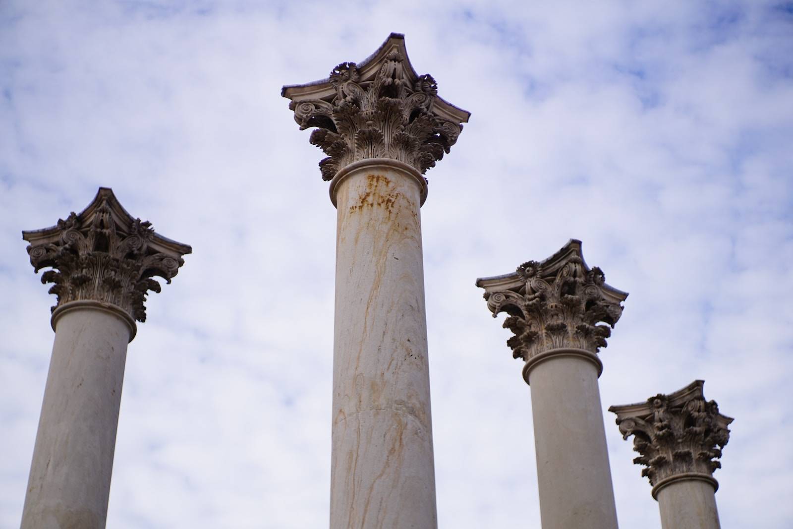 seo white concrete pillar under white clouds during daytime